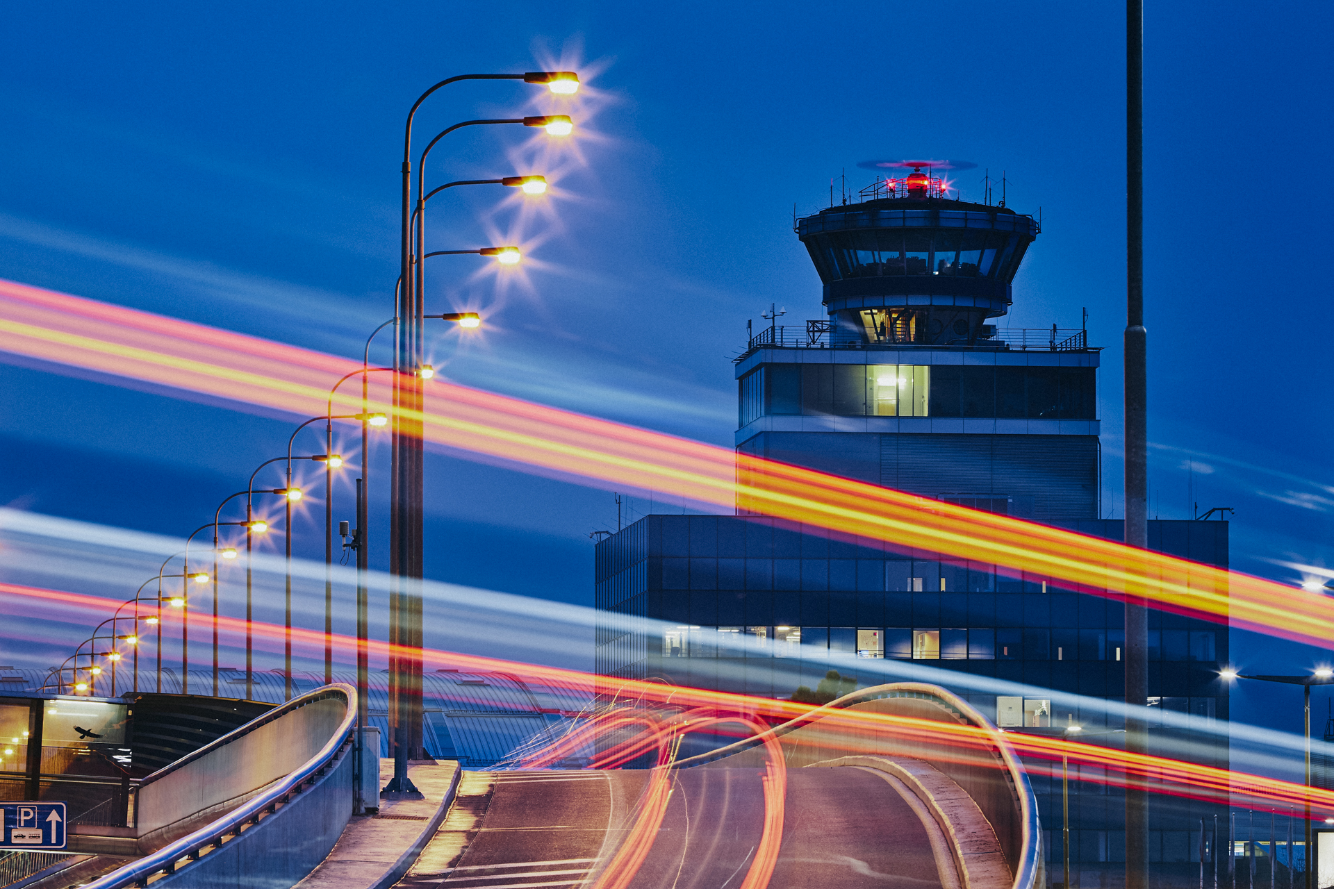 Control tower at night with light trails