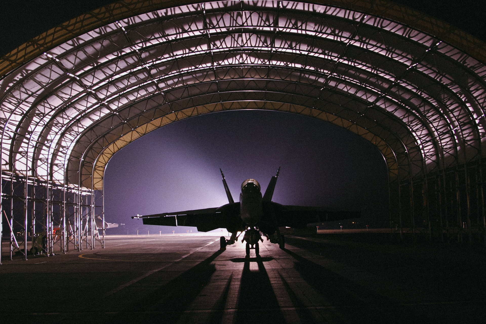 Fighter jet in hangar, dramatic lighting